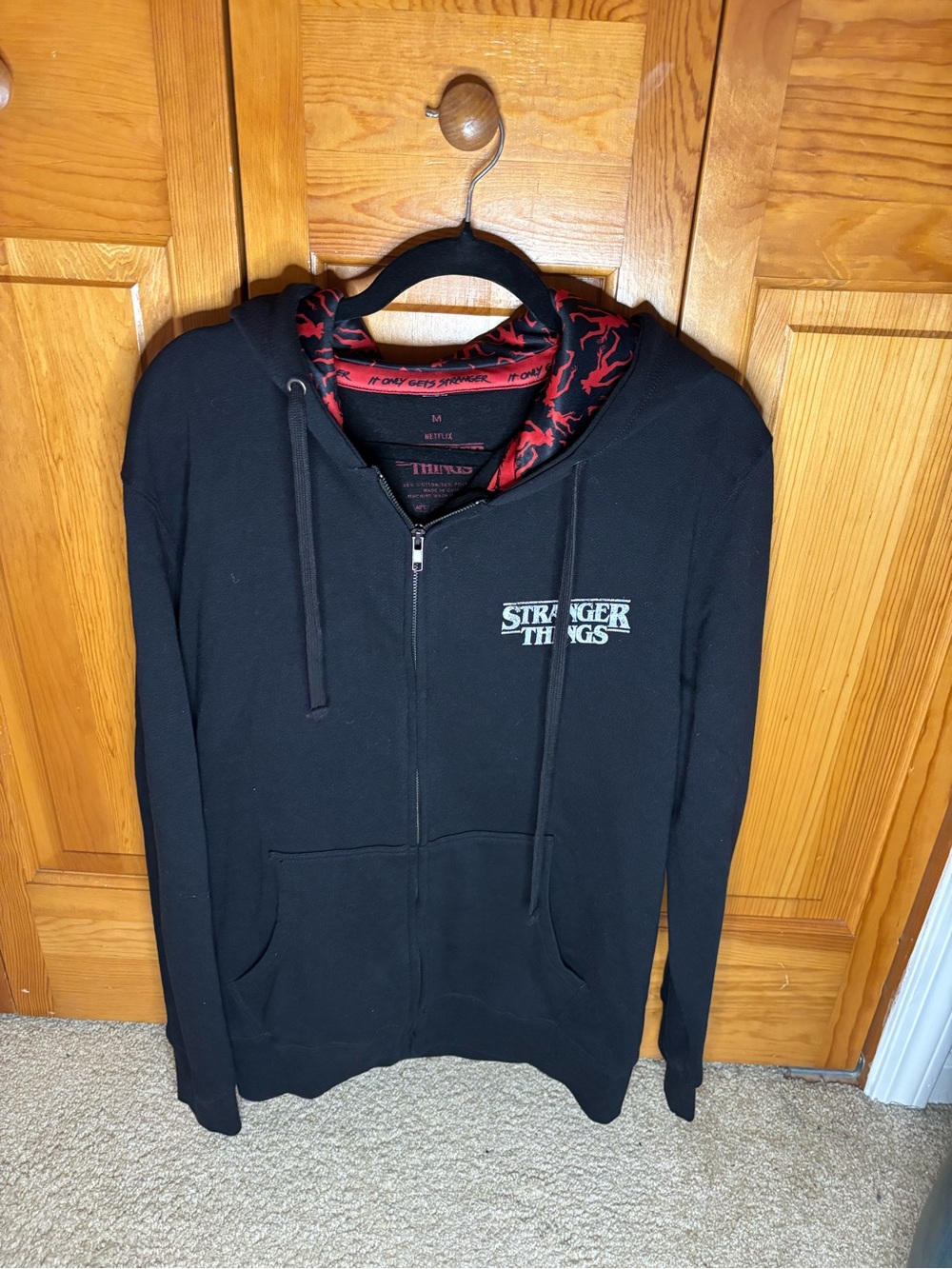 Netflix Stranger Things Black Zip-Up Sweater with Red Hood Lining